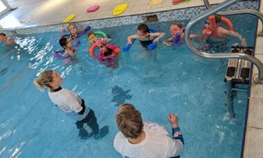 STA Gold Accredited Swim School Swim With Me swimming lesson with several children in pool